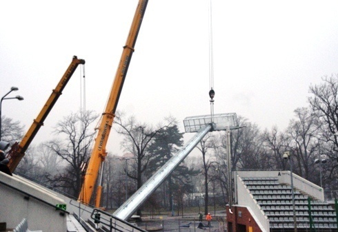 Potężne maszty oświetleniowe stają na stadionie 
